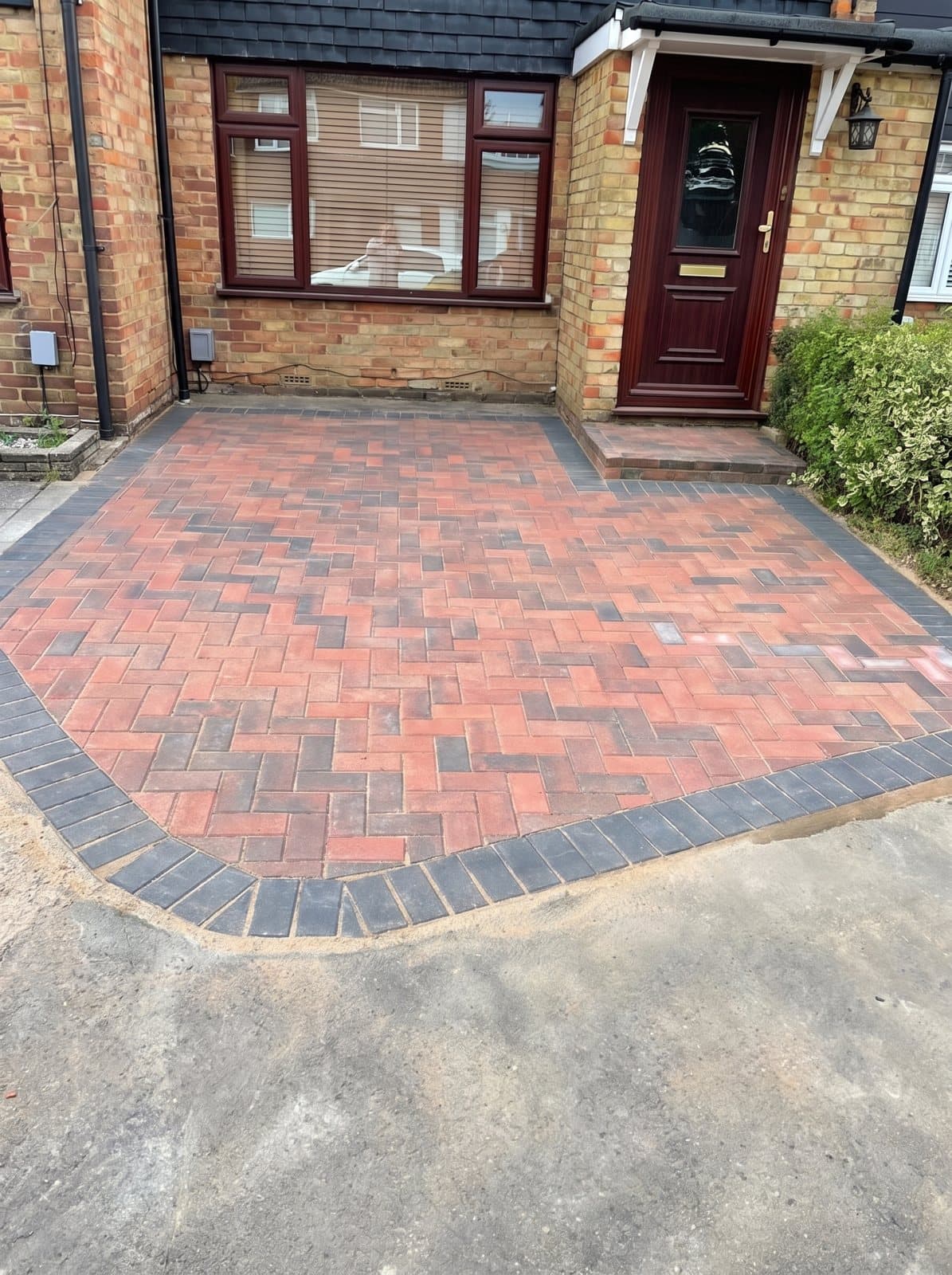 A herringbone brick front path