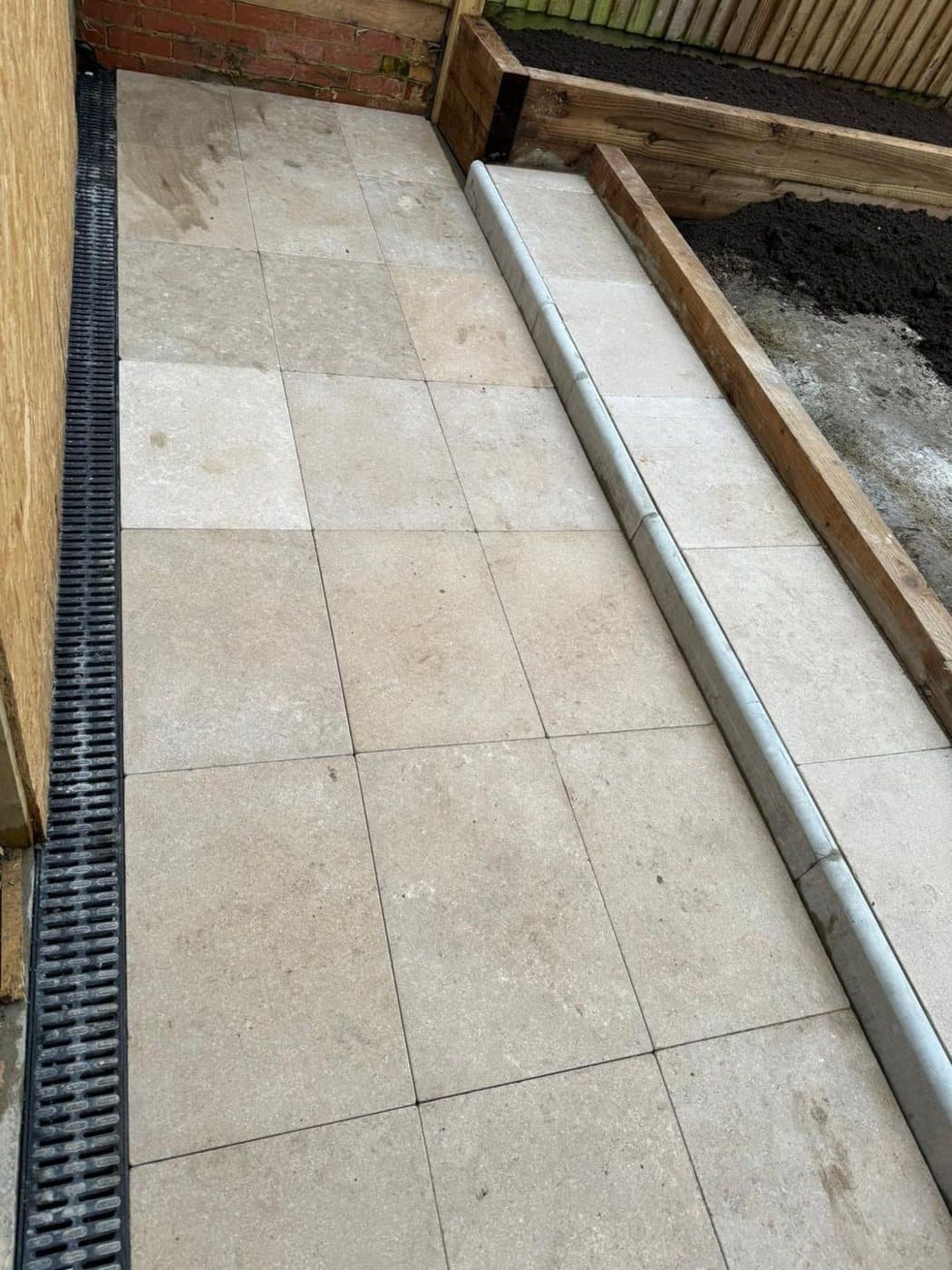 A drainage channel set into the new paving