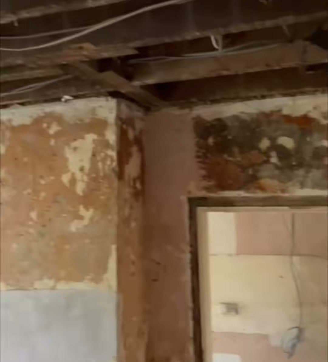 A room stripped back to bare brick